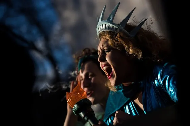 Dressed as the Statue of Liberty, Sonia Sheron cheers as she attends a rally to mark International Women's Day in Washington Square Park, March 8, 2017 in New York City. Thousands of women marked International Women's Day with a marches and rallies around the globe to support women's issues. (Photo by Drew Angerer/Getty Images)
