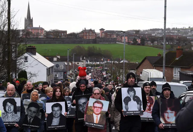 People hold pictures of the victims of “Bloody Sunday” as they retrace the steps of the original 1972 civil rights march, in a walk of remembrance to mark the 50th anniversary of “Bloody Sunday”, in Londonderry, Northern Ireland, January 30, 2022. In 1972 British soldiers shot 28 unarmed civilians at a civil rights march, killing 13 on what is known as Bloody Sunday or the Bogside Massacre. Sunday marks the 50th anniversary of the shootings in the Bogside area of Londonderry. (Photo by Clodagh Kilcoyne/Reuters)