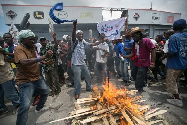 Supporters of the party Lavalas demonstrate in support of Haitian President Jocelerme Privert in the streets of Port-Au-Prince, Haiti, 04 May 2016. Privert said the agreement reached on last 05 February between Haitian former President Michel Martelly and the Parliament during the electoral crisis of the country over a provisional government, will remain until next elections. Elections that were scheduled in the country for 26 April 2016 were again postponed. (Photo by Bahare Khodabande/EPA)