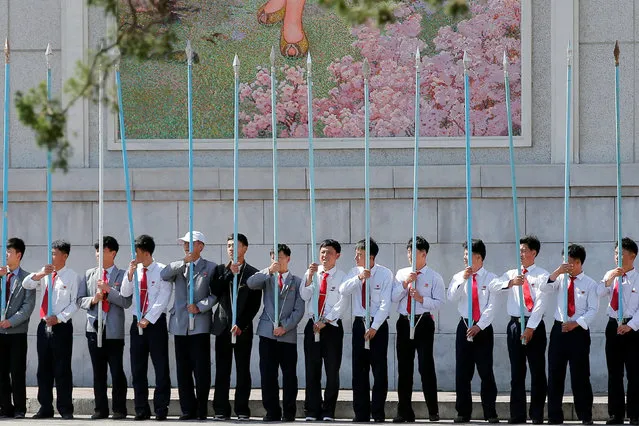 Students hold flag poles as they practice for an apparent parade to celebrate the Workers' Party of Korea (WPK) Congress in central Pyongyang, North Korea, May 7, 2016. (Photo by Damir Sagolj/Reuters)