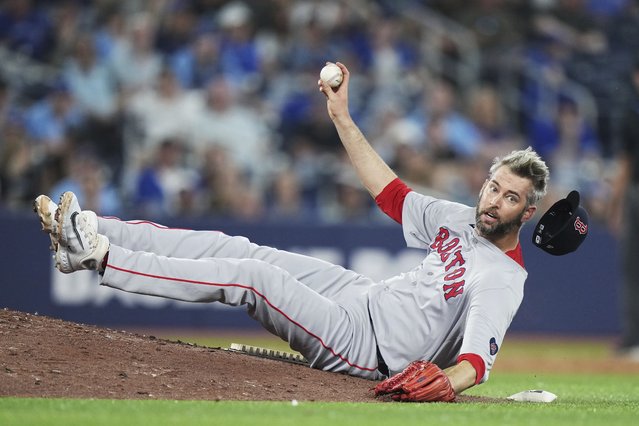 Boston Red Sox pitcher Chris Martin throws to first base as he trips on the mound fielding a ground ball against the Toronto Blue Jays during the ninth inning of a baseball action in Toronto on Wednesday, June 19, 2024. (Photo by Nathan Denette/The Canadian Press via AP Photo)