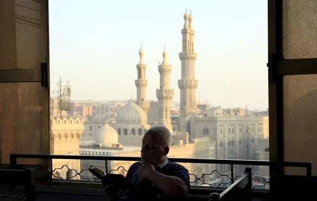 A man reads the Koran minutes before sunset as he waits to break his fast and have his Iftar meal near Al-Azhar mosque, in the old Islamic area of Cairo, Egypt, July 9, 2015. (Photo by Amr Abdallah Dalsh/Reuters)