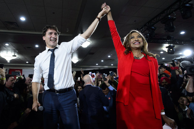 Liberal Leader Justin Trudeau hoists the hand of Liberal candidate Nirmala Naidoo as he attends a rally in Calgary, Saturday, October 19, 2019. (Photo by Sean Kilpatrick/The Canadian Press via AP Photo)