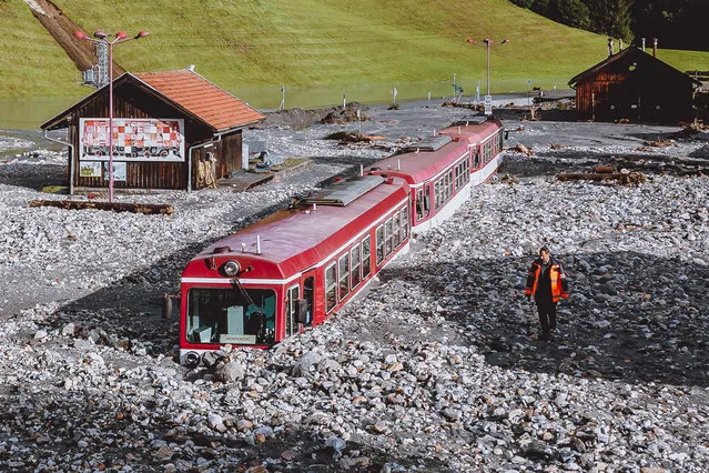 A stucked train after flooding is pictured in Wald im Pinzgau near Salzburg, Austria, on August 17, 2021. Storms have battered large parts of Austria since late August 16 with landslides and flooding hitting especially Austrias western regions of Pinzgau and Pongau in the state of Salzburg, bordering Germany. Some 100 people stuck in cars as landslides hit roads had to be rescued, while three people have been injured. (Photo by JFK/AFP Photo)