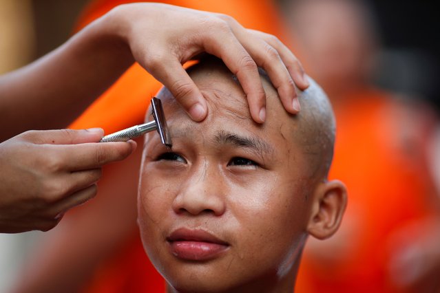 A young hill tribe boy has his hair and eyebrows shaved by a Buddhist monk during a head shaving rite of a mass Buddhist monk ordination ceremony for hill tribe men and youngsters at Wat Benchamabophit, also known as the Marble Temple in Bangkok, Thailand, 05 July 2024. A total of 191 hill tribe men including young boys were to be ordained as Buddhist monks and novices in the annual mass ordination ceremony to mark the three-month Buddhist Lent which this year begins on 21 July as well as to honor the King's 72nd birthday anniversary on 28 July. For the duration of the Buddhist Lent, monks remain in one location, typically in a monastery or on temple grounds, where they engage in meditation and prayer, while laymen choose to observe Lent by giving up meat, alcohol, and perform other ascetic practices. In Thailand, a Buddhist man is expected to become a monk during some period of his life. (Photo by Rungroj Yongrit/EPA/EFE)