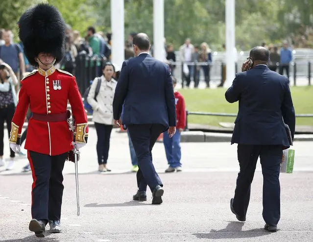A Royal Household Guard uses a pedestrian crossing on the Mall near to Buckingham Palace, London, Britain May 16, 2016. (Photo by Peter Nicholls/Reuters)