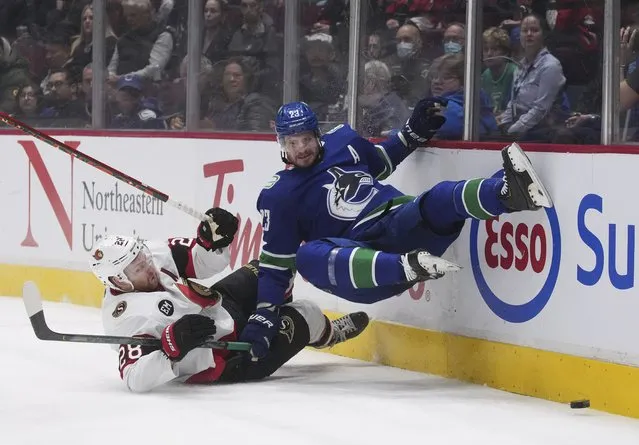 Ottawa Senators' Connor Brown, left, and Vancouver Canucks' Oliver Ekman-Larsson collide during the first period of an NHL hockey game Tuesday, April 19, 2022, in Vancouver, British Columbia. (Photo by Darryl Dyck/The Canadian Press via AP Photo)