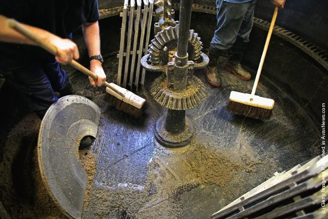 Workers clear out the Mash Tun at Edradour distillery on March 26, 2012 in Pitlochry, United Kingdom