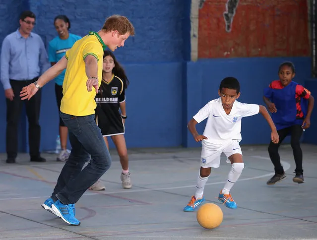 Prince Harry plays football as he visits the ACER Charity for disadvantaged children on June 25, 2014 in Sao Paulo, Brazil. Prince Harry is on a four day tour of Brazil that will be followed by two days in Chile. (Photo by Chris Jackson/Getty Images)