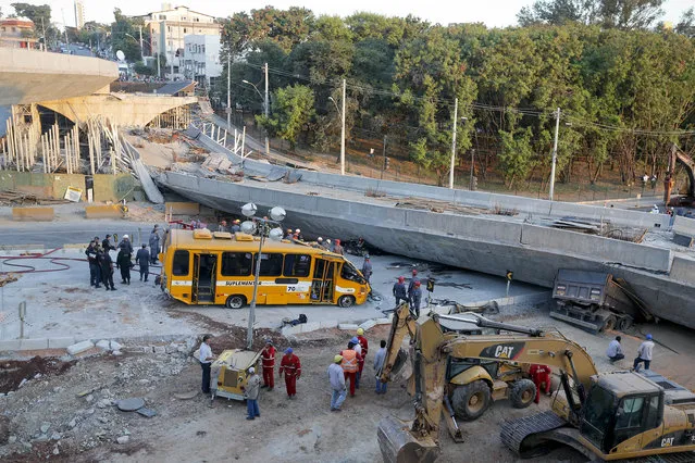 A bus sits damaged next to a bridge after it collapsed in Belo Horizonte, Brazil, Thursday, July 3, 2014. The overpass under construction collapsed Thursday in the Brazilian World Cup host city. The incident took place on a main avenue, the expansion of which was part of the World Cup infrastructure plan but, like most urban mobility projects related to the Cup, was not finished on time for the event. (Photo by Victor R. Caivano/AP Photo)