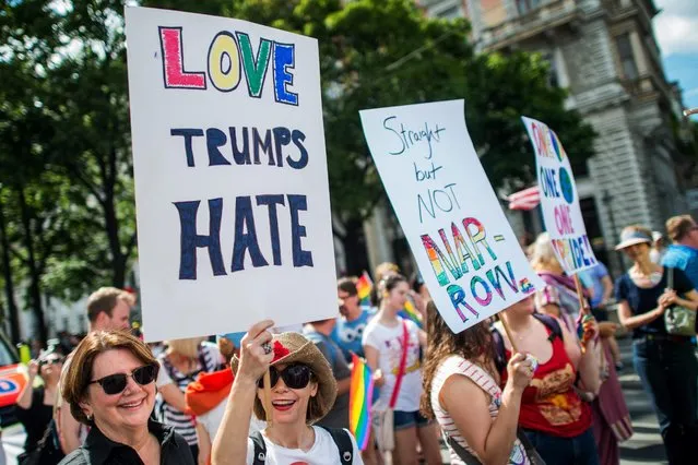 Participants display banners reading 'Love Trumps Hate' during the 21st Rainbow Parade in Vienna, Austria, 18 June 2016. (Photo by Christian Bruna/EPA)