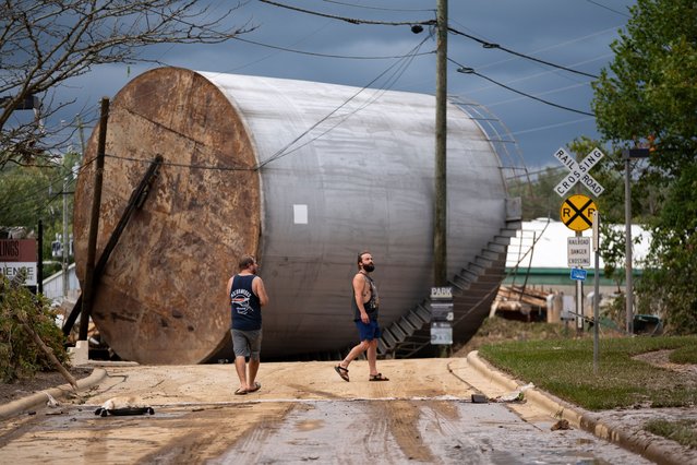 Men inspect the damage from flooding in the Biltmore Village in the aftermath of Hurricane Helene on September 28, 2024 in Asheville, North Carolina. Hurricane Helene made landfall Thursday night in Florida's Big Bend with winds up to 140 mph. (Photo by Sean Rayford/Getty Images)