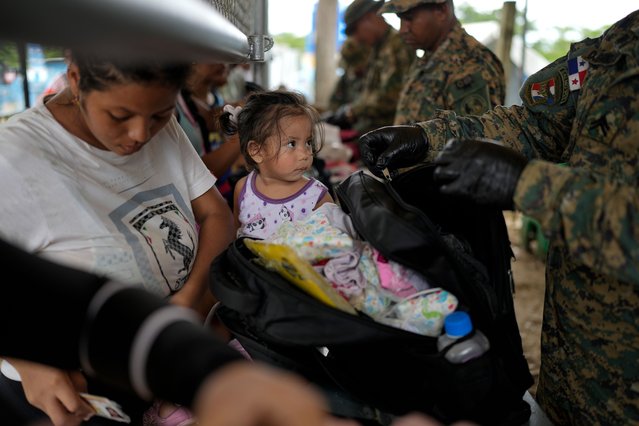 Panamanian police inspect the luggage of Francismar Acosta, from Venezuela, in Lajas Blancas, Panama, after she trekked across the Darien Gap from Colombia with her daughter Adhara Figueroa, Thursday, September 26, 2024. (Photo by Matias Delacroix/AP Photo)