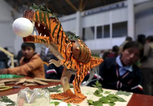A dinosaur robot built with recycled materials is pictured during the annual robotics fair supported by the Bolivian Education Ministry in La Paz, August 10, 2015. (Photo by David Mercado/Reuters)