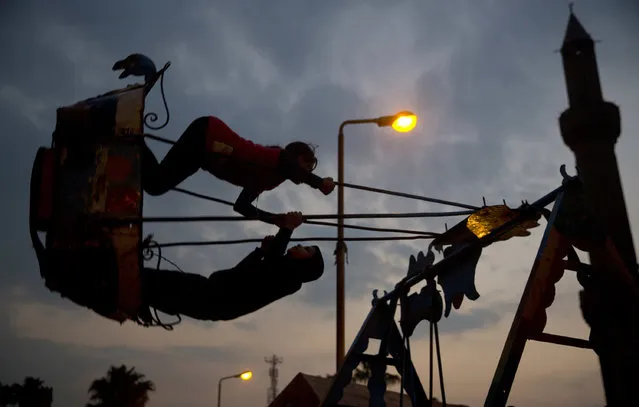 A couple swings as they celebrate Moulid Al-Rifa'i, a Sufi gathering which commemorates the birth of the Muslim Sufi spiritual leader Ahmed Al-Rifa'i, in Cairo, Egypt, Thursday, March 16, 2017. The event attracts thousands of Muslims from all over the country to the mosque and shrine named after him. (Photo by Amr Nabil/AP Photo)