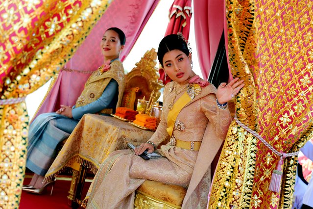 This handout picture taken and released by Thai Royal Household Bureau on December 12, 2019 shows Thailand's Princess Bajrakitiyabha (L) and Princess Sirivannavari sit in their barge during the Royal Barge procession in Bangkok. The Royal barge procession is the final event of the coronation of Thailand’s King Maha Vajiralongkorn. (Photo by Thai Royal Household Bureau via AFP Photo/Handout)