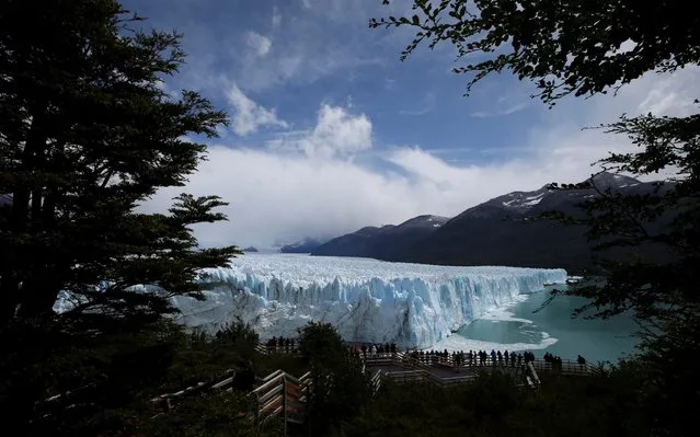 Tourists look at the Perito Moreno glacier, near the city of El Calafate in the Patagonian province of Santa Cruz, Argentina on January 14, 2020. (Photo by Agustin Marcarian/Reuters)