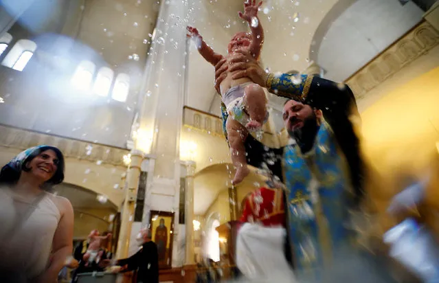 A baby is baptised during a mass baptism ceremony at the Holy Trinity Cathedral in Tbilisi, Georgia July 13, 2016. (Photo by David Mdzinarishvili/Reuters)