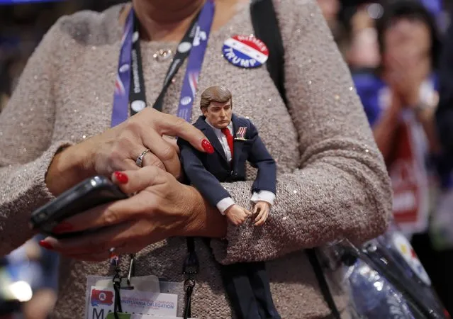 A delegate holds a Donald Trump doll during the second day of the Republican National Convention in Cleveland, Ohio, U.S. July 19, 2016. (Photo by Brian Snyder/Reuters)