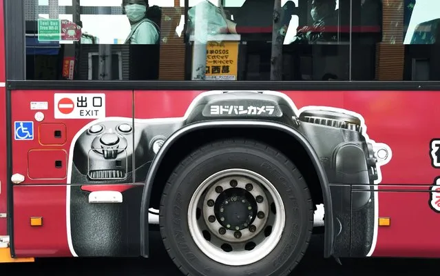 People wearing face masks as they ride a bus in Edogawa-ku, Japan on March 29, 2020. Tokyo Governor Yuriko Koike asked residents to refrain from all non-essentials and abstain from going out this weekend to prevent an increase of coronavirus infection cases in the city. (Photo by Ramiro Agustin Vargas Tabares/Zuma Press)