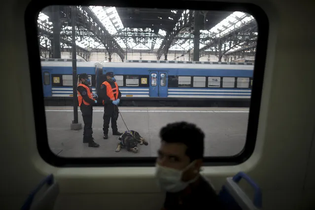 Police guard a train station during a government-ordered lockdown to curb the spread of the new coronavirus, in Buenos Aires, Argentina, Friday, April 24, 2020. (Photo by Natacha Pisarenko/AP Photo)