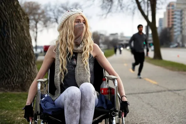 Colleen Curtin, who says she is suffering from health issues that have not been able to be diagnosed by testing due to the current circumstances, sits in her wheelchair for a portrait as the spread of the coronavirus disease (COVID-19) continues, along a path in Madison, Wisconsin, U.S., April 17, 2020. (Photo by Shannon Stapleton/Reuters)