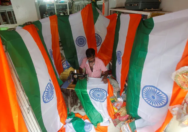 A worker stitches national flags at a workshop ahead of India's Independence Day celebrations in Agartala, India August 2, 2016. (Photo by Jayanta Dey/Reuters)