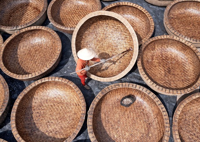Carpenters at work on traditional basket boats in Phu Yen, Vietnam in the second decade of November 2024. The bamboo design emerged for fishermen unable to afford the taxes for conventional boats. Each is coated in a protective resin and can last for decades. (Photo by Sabina Akter/Solent News)