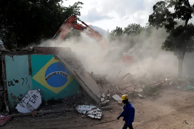 The house of Carlos Augusto and Sandra Regina (not pictured) who have lived in Vila Autodromo slum for 20 years with their children, is demolished after the family moved to one of the twenty houses built for the residents who refused to leave the community, in Rio de Janeiro, Brazil, August 2, 2016. (Photo by Ricardo Moraes/Reuters)