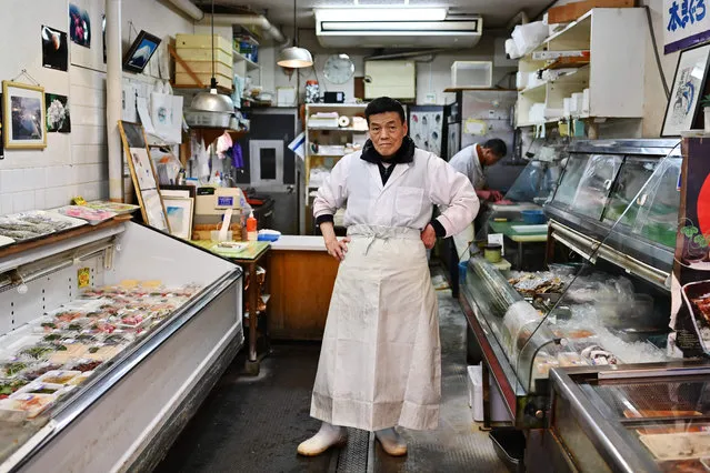 Japanese Kunio Hayakawa, 72, fishmonger, poses for a picture at his shop in Tokyo on April 21, 2020 during the COVID-19 coronavirus pandemic. Ahead of May Day on May 1, 2020, AFP portrayed 55 workers defying the novel coronavirus around the world. Kunio Hayakawa decided to keep his shop open because he wanted to do “everything for Shinagawa people”. He said there are no changes due to the virus, with the same number of customers, and that he “will stay open until the end (of the crisis)” or until the government says so. (Photo by Charly Triballeau/AFP Photo)