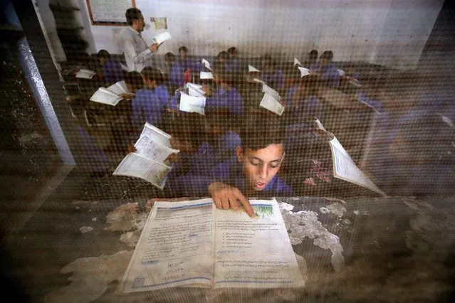 Pakistani boys attend a class on the International Literacy Day in Peshawar, Pakistan, 08 September 2022. International Literacy Day is observed on 08 September annually and this year's theme is 'Transforming Literacy Learning Spaces' and its focus is aimed at urging people 'to rethink the fundamental importance of literacy learning spaces to build resilience and ensure quality, equitable, and inclusive education for all', as the United Nations Educational, Scientific and Cultural Organization (UNESCO) defines it on their website. (Photo by Bilawal Arbab/EPA/EFE/Rex Features/Shutterstock)