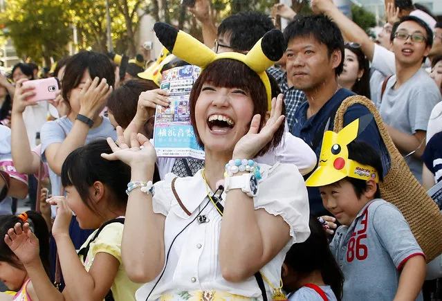 People react as performers splash water during a Pokemon parade in Yokohama, Japan, August 7, 2016. (Photo by Kim Kyung-Hoon/Reuters)