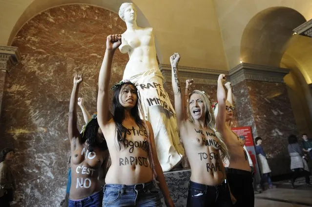 Topless activists of the Ukrainian feminist group Femen demonstrate in front of the Aphrodite of Milos statue in the Louvre Museum, Paris, France, 03 October 2012. Femen activists have become internationally known for organizing topless protests against s*x tourists, religious institutions, international marriage agencies, sexism and other social, national and international topics. EPA/YOAN VALAT