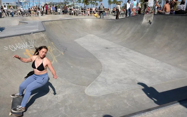 A skater rides her board after a group of grassroots volunteers removed sand from the Venice Skate Park on May 25, 2020 in Venice, California. The iconic skate park has been filled with sand since late April in an effort to curb the spread of COVID-19. (Photo by Amanda Edwards/Getty Images)