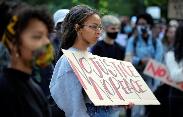 A woman holds a placard as people attend a protest against the fatal injury inflicted by Minneapolis police on African-American man George Floyd, in Berlin, Germany, May 30, 2020. (Photo by Christian Mang/Reuters)