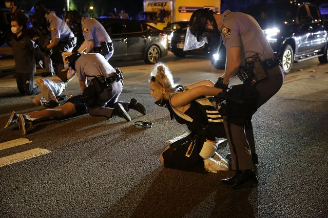 People are detained during protests Saturday, June 13, 2020, near the Atlanta Wendy's where Rayshard Brooks was shot and killed by police Friday evening following a struggle in the restaurant's drive-thru line in Atlanta. (Photo by Brynn Anderson/AP Photo)