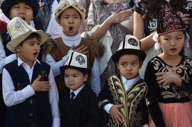 Children attend the celebrations marking the National Flag Day and the Day of Kyrgyz national “Ak-kalpak” hat at the central Ala-Too Square in Bishkek on March 4, 2021. (Photo by Vyacheslav Oseledko/AFP Photo)