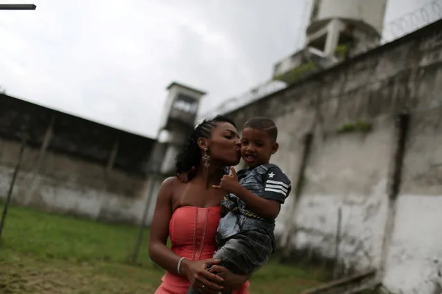 A prisoner and participant of the “TB Girl” beauty contest holds her son at the Talavera Bruce women prison in Rio de Janeiro, Brazil on Thursday, November 23, 2017. (Photo by Pilar Olivares/Reuters)