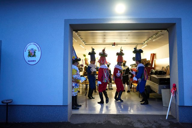 Revelers dance during a traditional carnival to celebrate the departing winter and forthcoming spring in the village of Hamry, Czech Republic, Saturday, January 27, 2024. The carnival is part of a centuries old tradition called the Shrovetide Procession which takes place in Eastern Bohemia near the end of winter and before Christian Lent. Experts trace the event, also known as Masopust, with its vibrant colors and archaic masks to pre-christian paganism, then common in the area. (Photo by Petr David Josek/AP Photo)