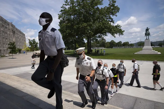 A formation of new cadets marches in formation, Monday, July 13, 2020, at the U.S. Military Academy in West Point, N.Y. The Army is welcoming more than 1,200 candidates from every state. Candidates will be COVID-19 tested immediately upon arrival, wear masks, and practice social distancing. (Photo by Mark Lennihan/AP Photo)