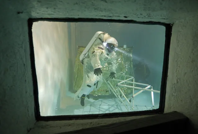 National Diver School director Jerome Vincent, wearing a Gandolfi space suit, trains in a swimming pool in Marseille October 22, 2014. (Photo by Jean-Paul Pelissier/Reuters)