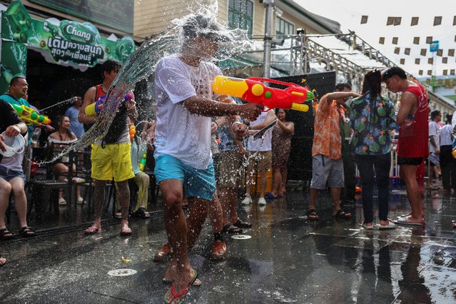 Revellers play with water as they celebrate the Songkran holiday, which marks the Thai New Year, in Bangkok, Thailand, on April 12, 2025. (Photo by Chalinee Thirasupa/Reuters)