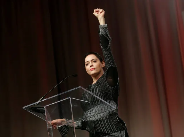 Actor Rose McGowan raises her fist after addressing the audience during the opening session of the three-day Women's Convention at Cobo Center in Detroit, Michigan, October 27, 2017. (Photo by Rebecca Cook/Reuters)