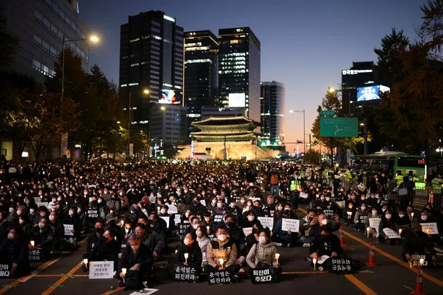 People attend a candlelight vigil to commemorate the victims of the crowd crush that happened during Halloween festivities, at Seoul City Hall Plaza, in Seoul, South Korea on November 5, 2022. (Photo by Kim Hong-Ji/Reuters)