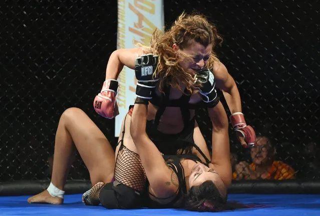 Fighters Natasha “Rattlesnake” Rodriguez (top) and Jesse “El Toro” Santos compete during “Lingerie Fighting Championships 21: Naughty 'n Nice” at the Robinson Rancheria Resort & Casino on June 18, 2016 in Nice, California. Santos won the bout. (Photo by Ethan Miller/Getty Images for LFC)