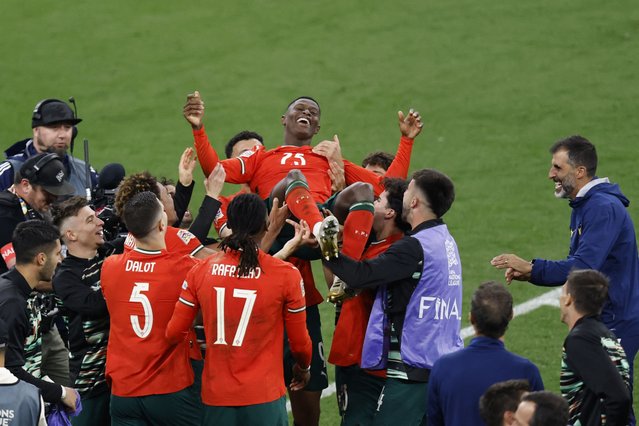 Portugal's defender #25 Nuno Mendes (top) is celebrated after winning the UEFA Nations League final football match between Portugal and Spain in Munich, southern Germany on June 8, 2025. (Photo by Alexandra Beier/AFP Photo)
