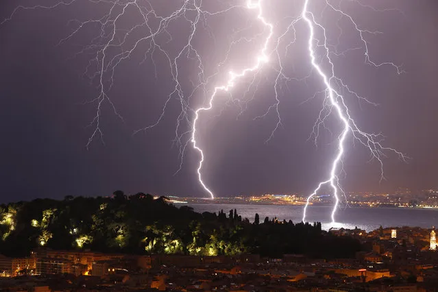 Flashes of lightning strike above the “Baie des Anges”, on October 4, 2013, in Nice, southeastern France. (Photo by Valery Hache/AFP Photo)