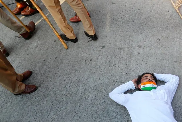 A worker of India's main opposition congress party lies on the ground after being injured during a protest following the death of a rape victim, in Noida, India, October 3, 2020. (Photo by Adnan Abidi/Reuters)