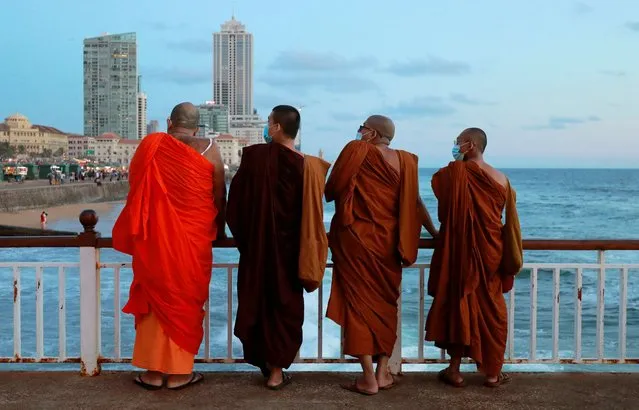 Buddhist monks wearing protective masks are seen on a deck at a beach, amid concerns about the spread of the coronavirus disease (COVID-19), in Colombo, Sri Lanka on August 24, 2020. (Photo by Dinuka Liyanawatte/Reuters)