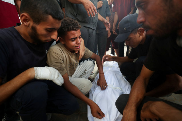 Mourners attend the funeral of Palestinians, who were killed by Israeli fire while trying to receive aid on Tuesday, according to medics, at Al-Shifa Hospital, in Gaza City, on July 30, 2025. (Photo by Mahmoud Issa/Reuters)